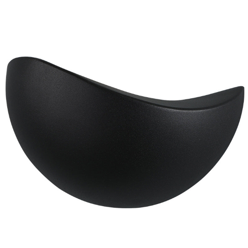 Black half-moon object on a white background