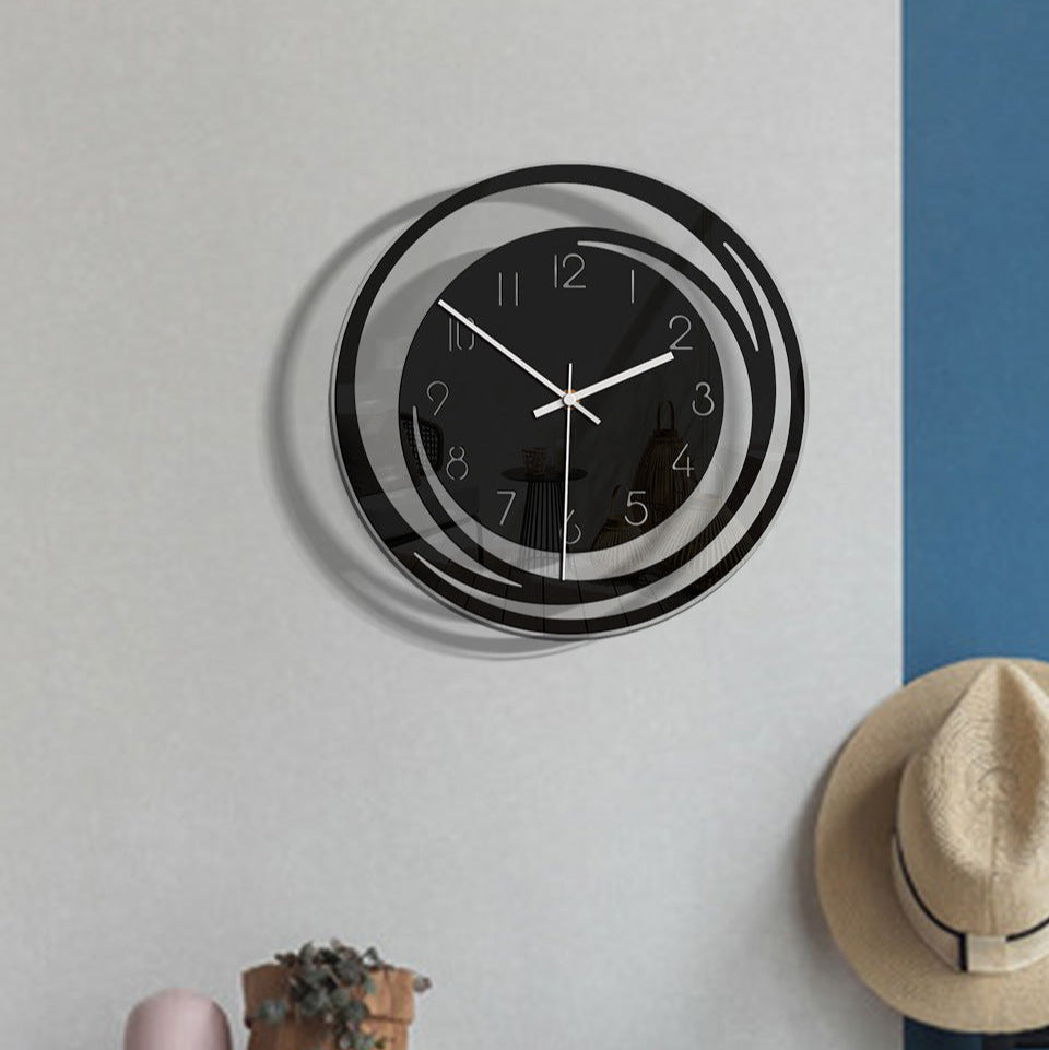 Wall clock on a wall with a hat and plant below