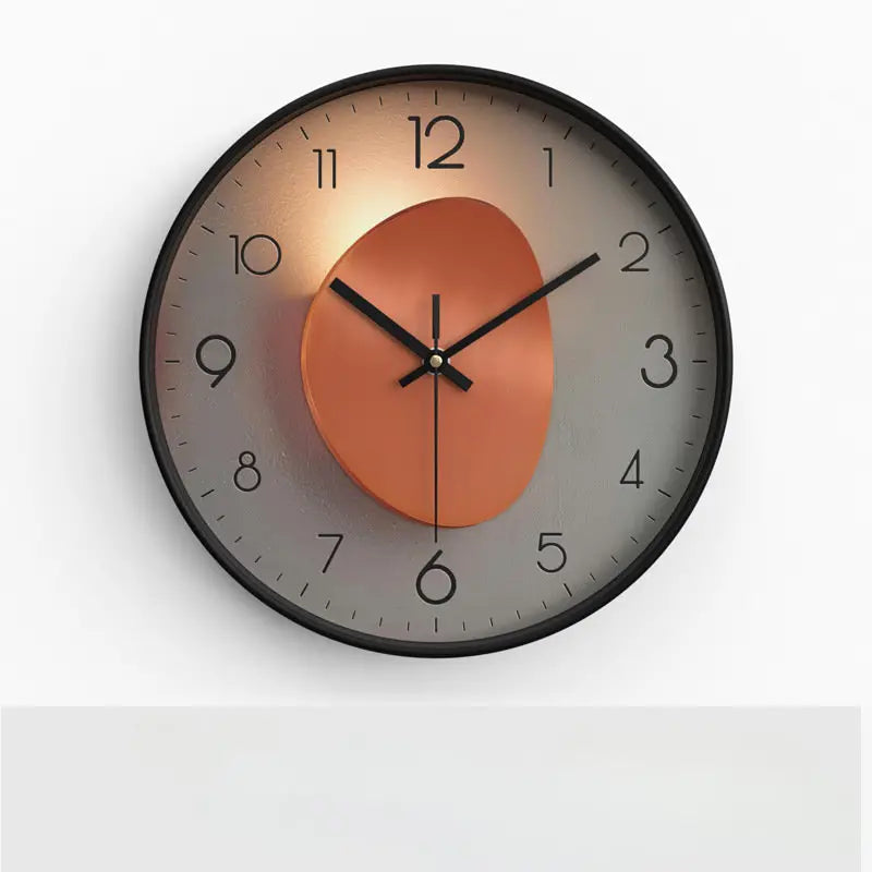 Wall clock with a round orange face and black frame on a white background