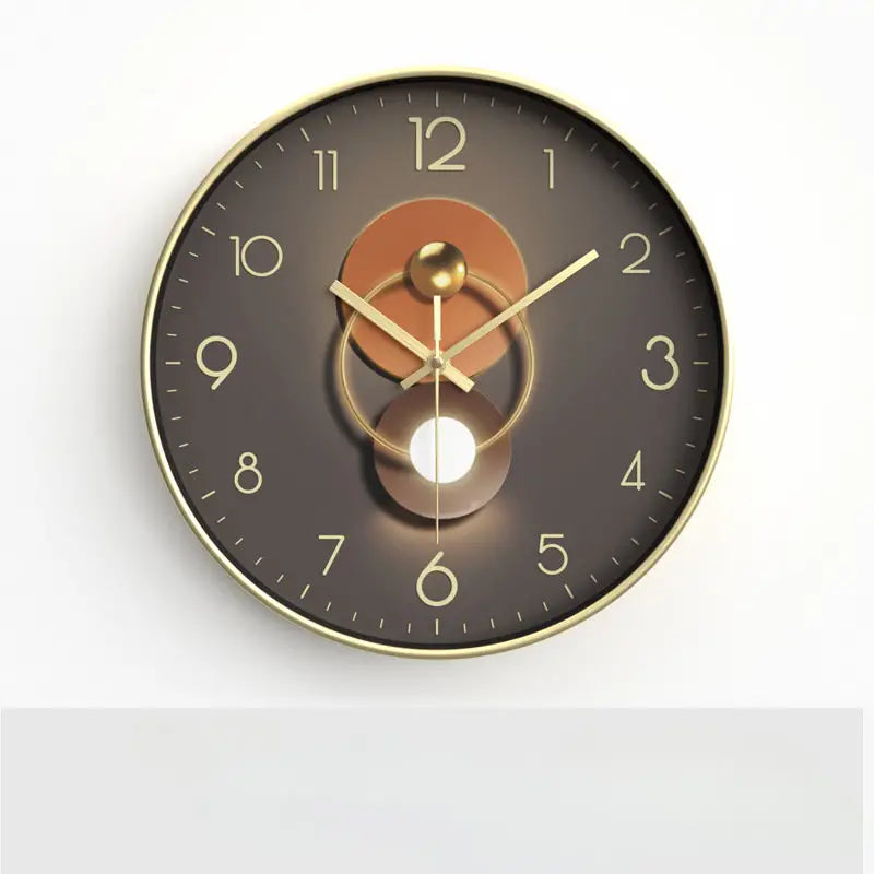 Round wall clock with gold frame and brown face on a white background