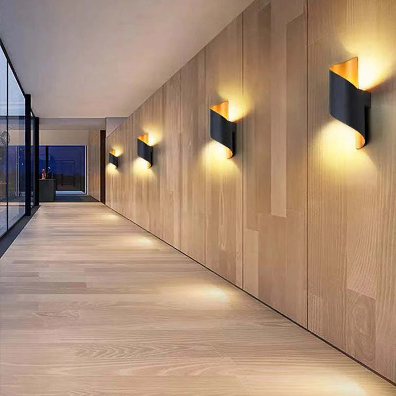 Modern wall lights on a wooden panelled wall in a hallway