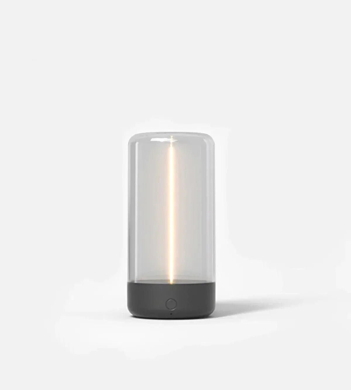 Small cylindrical lamp with a clear glass cover and black base on a white background