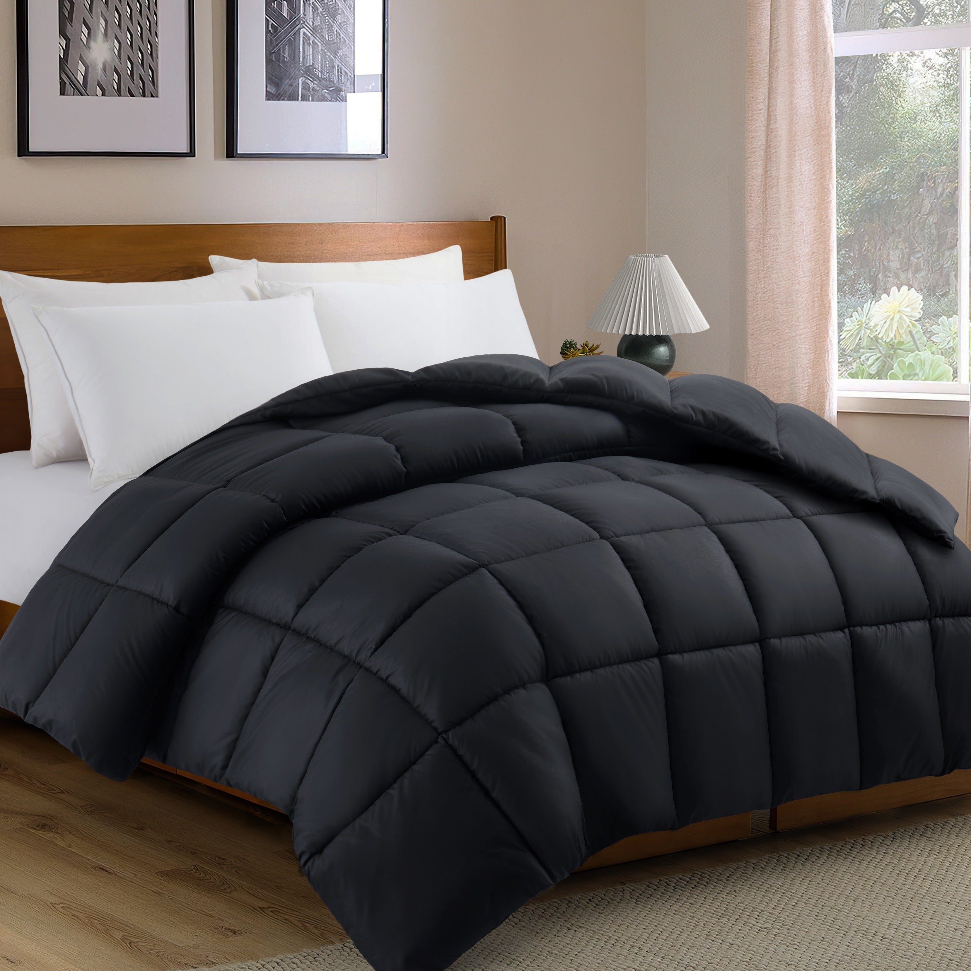 Black comforter on a bed in a bedroom with a lamp and window.