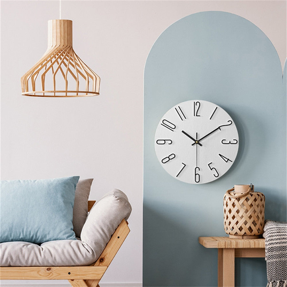 Modern interior with a wooden pendant light, round wall clock, and a sofa against a light blue wall.