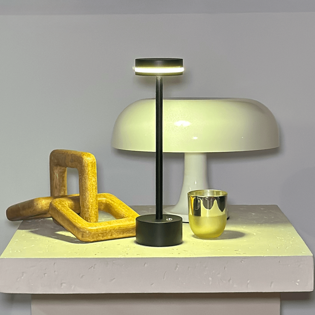 Modern table lamp with a unique base on a light gray surface.