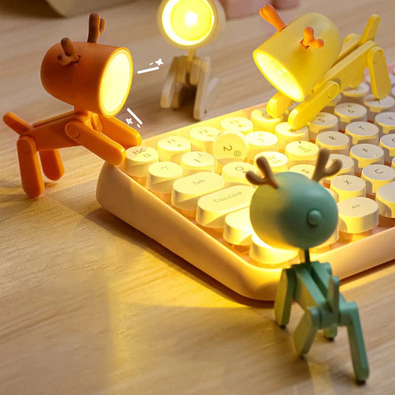 Toy figures around a glowing keyboard on a wooden surface