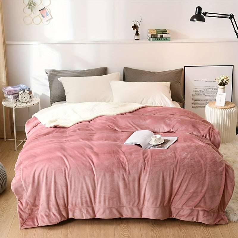 Bed with pink comforter and pillows in a bedroom setting