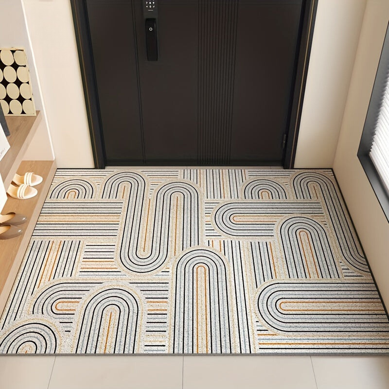Decorative doormat with geometric pattern in front of a black door