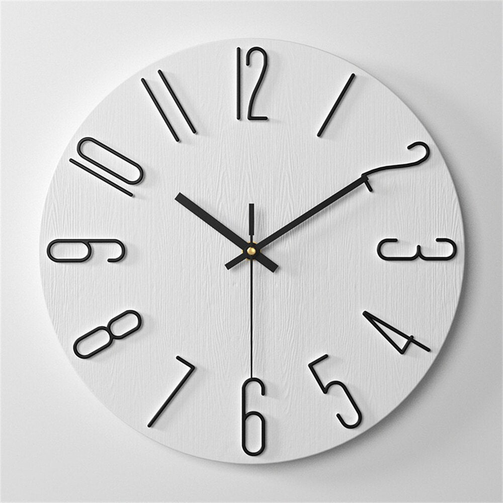 Round wall clock with black numbers and hands on a white background