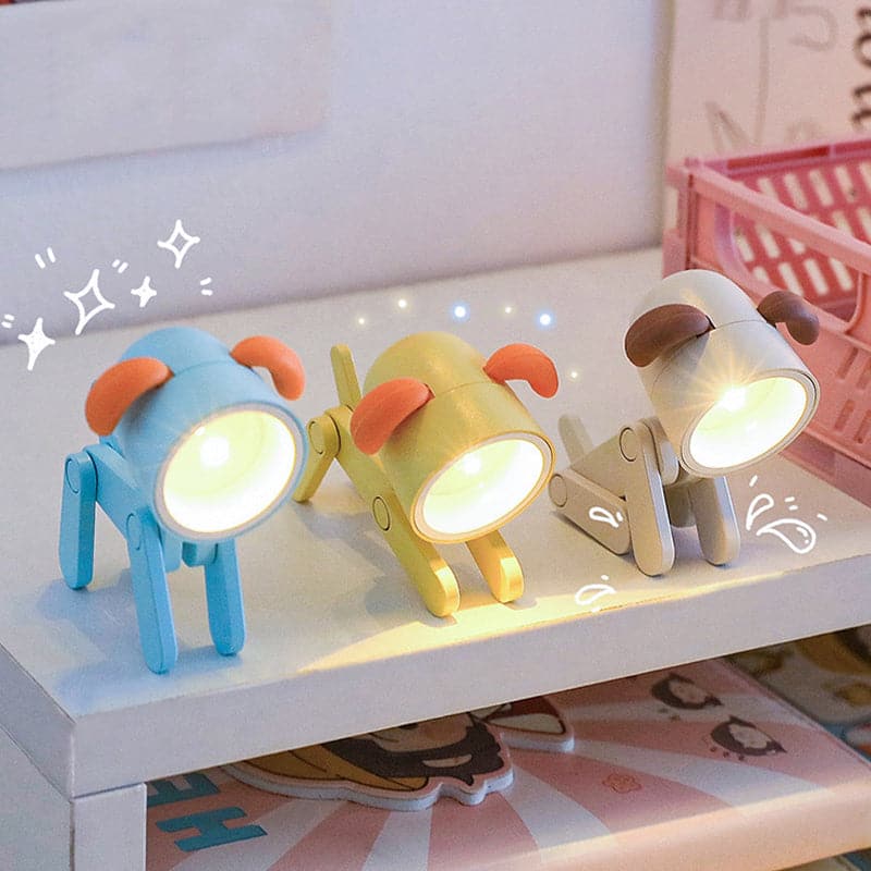 Three colorful dog-shaped night lights on a shelf with a soft focus background.