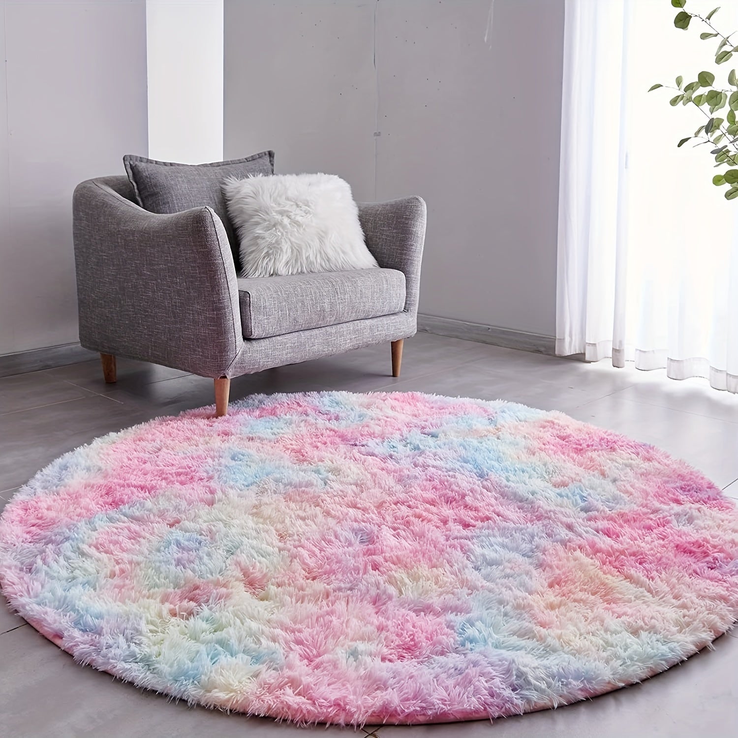 Round multicolored rug in a living room with a gray sofa.