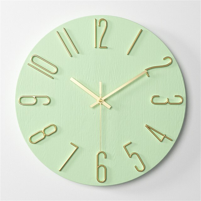 Green wall clock with gold hour markers on a light gray background