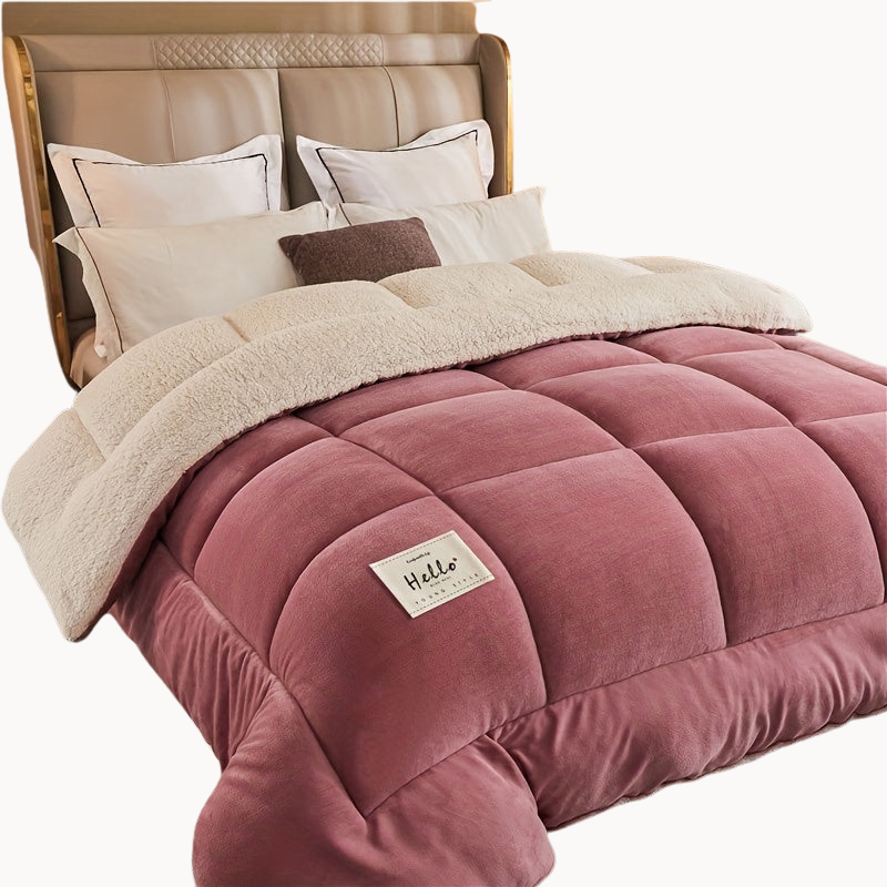 Pink comforter with a label on a bed in a bedroom setting