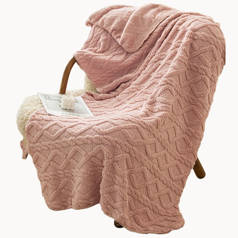 Pink textured blanket draped over a chair in a beige background