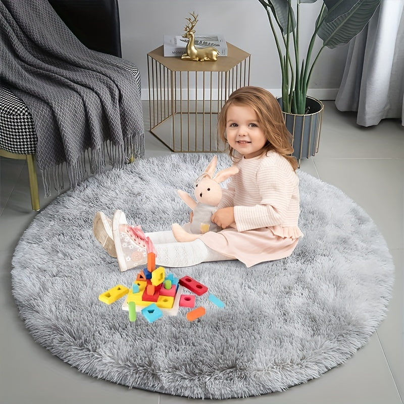 Child sitting on a fluffy gray rug with toys in a cozy living room.