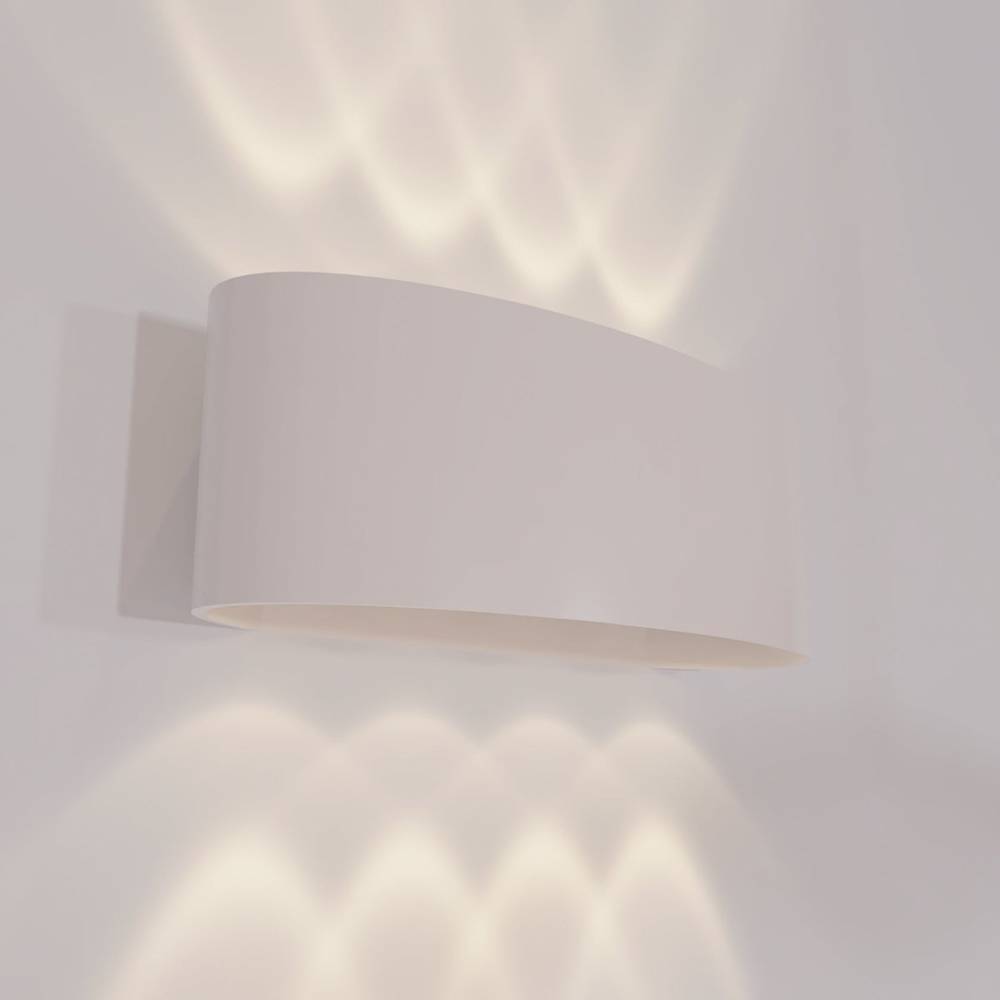 White wall-mounted lamp casting light on a plain wall