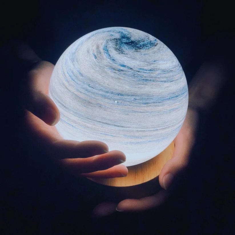 Holding a spherical light source with a planetary design in a dark setting