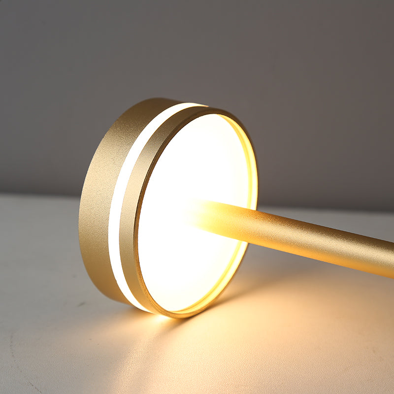 Gold cylindrical light fixture on a neutral background