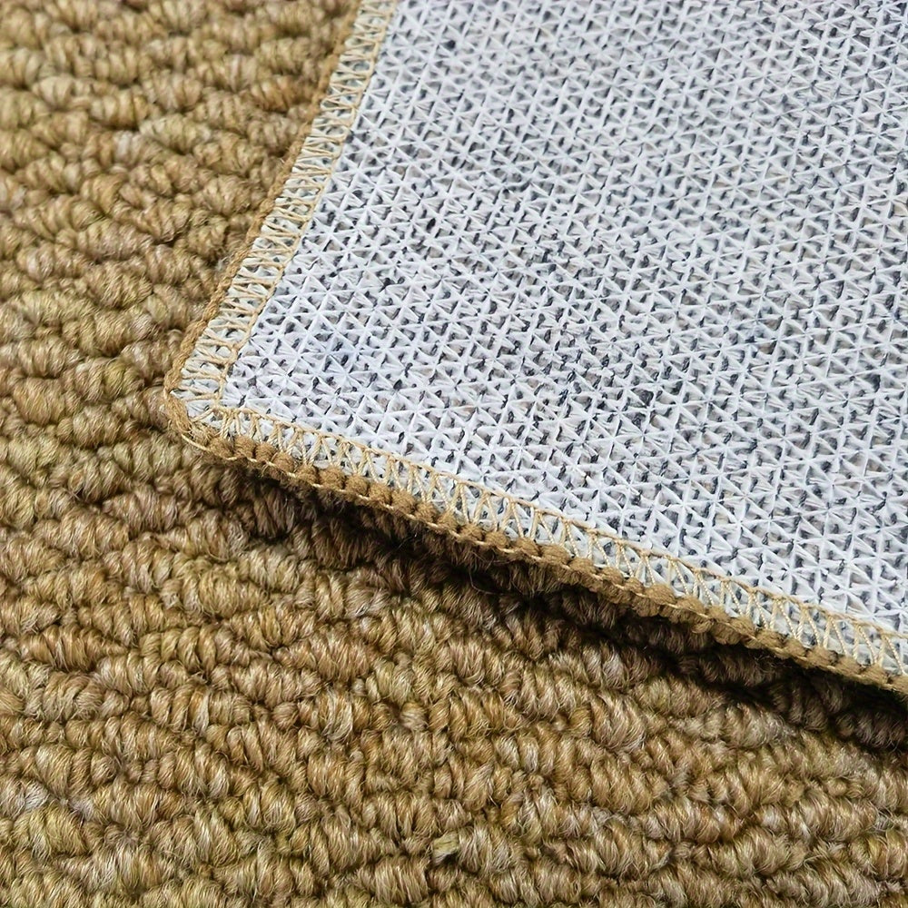 Close-up of a textured beige carpet corner with a white underlay.