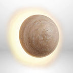 Round wall light on a textured wall.