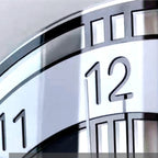 Close-up of a clock face with the number 12 prominently displayed.