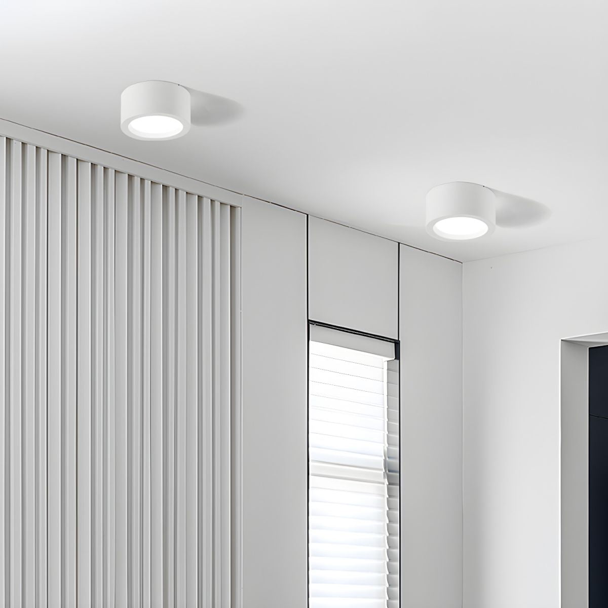 Two ceiling lights in a modern interior setting with a neutral color palette.