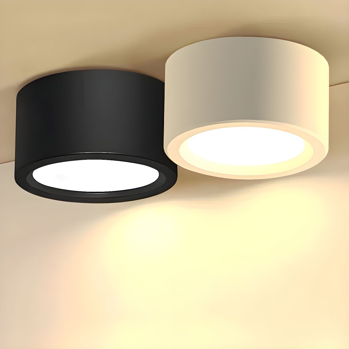 Two cylindrical ceiling lights, one black and one beige, on a neutral background.
