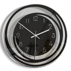 Wall clock with black face and silver frame on a white background
