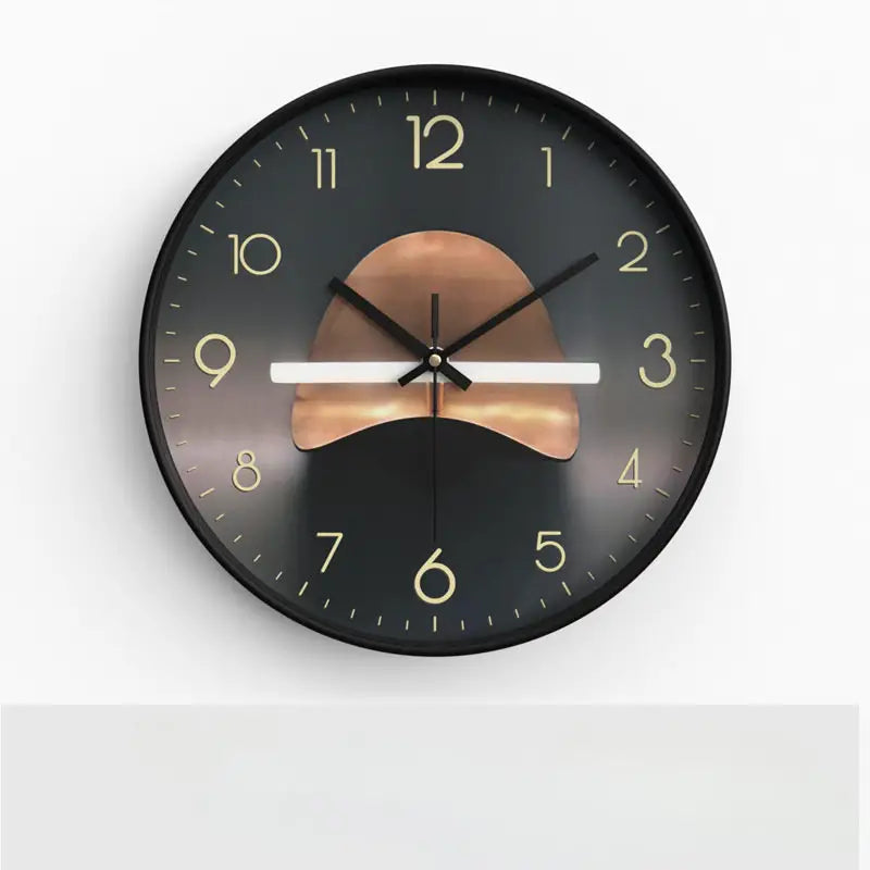 Round wall clock with black frame and gold numbers on a white background