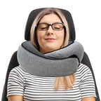 Woman using a gray neck pillow in a car seat with a small black bag beside her.