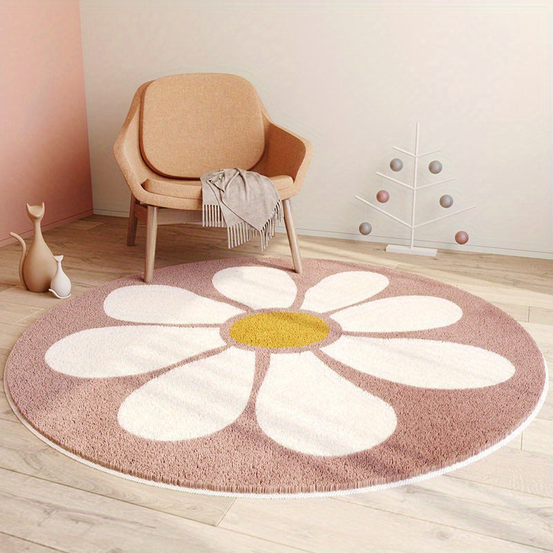 Round flower-shaped rug with a yellow center on a wooden floor, next to a beige armchair.