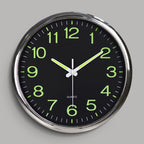 Wall clock with green numbers on a black face against a gray background