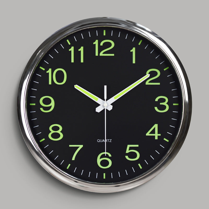 Wall clock with green numbers on a black face against a gray background