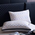 Two white pillows with geometric patterns on a bed with a dark headboard.