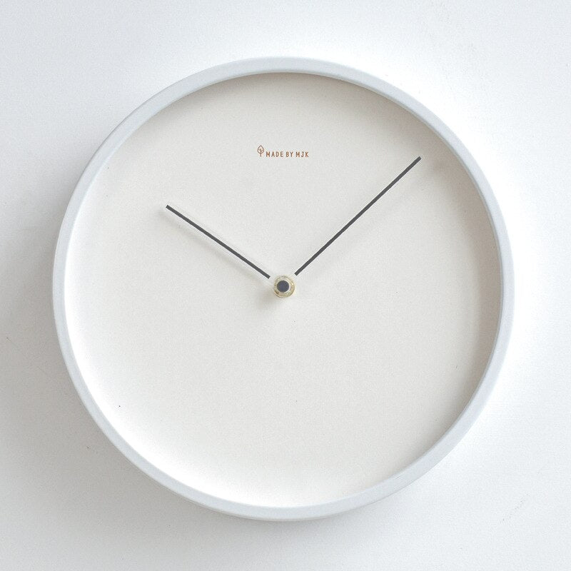 White wall clock with black hands on a white background