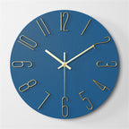 Blue wall clock with gold hands and numbers on a light gray background