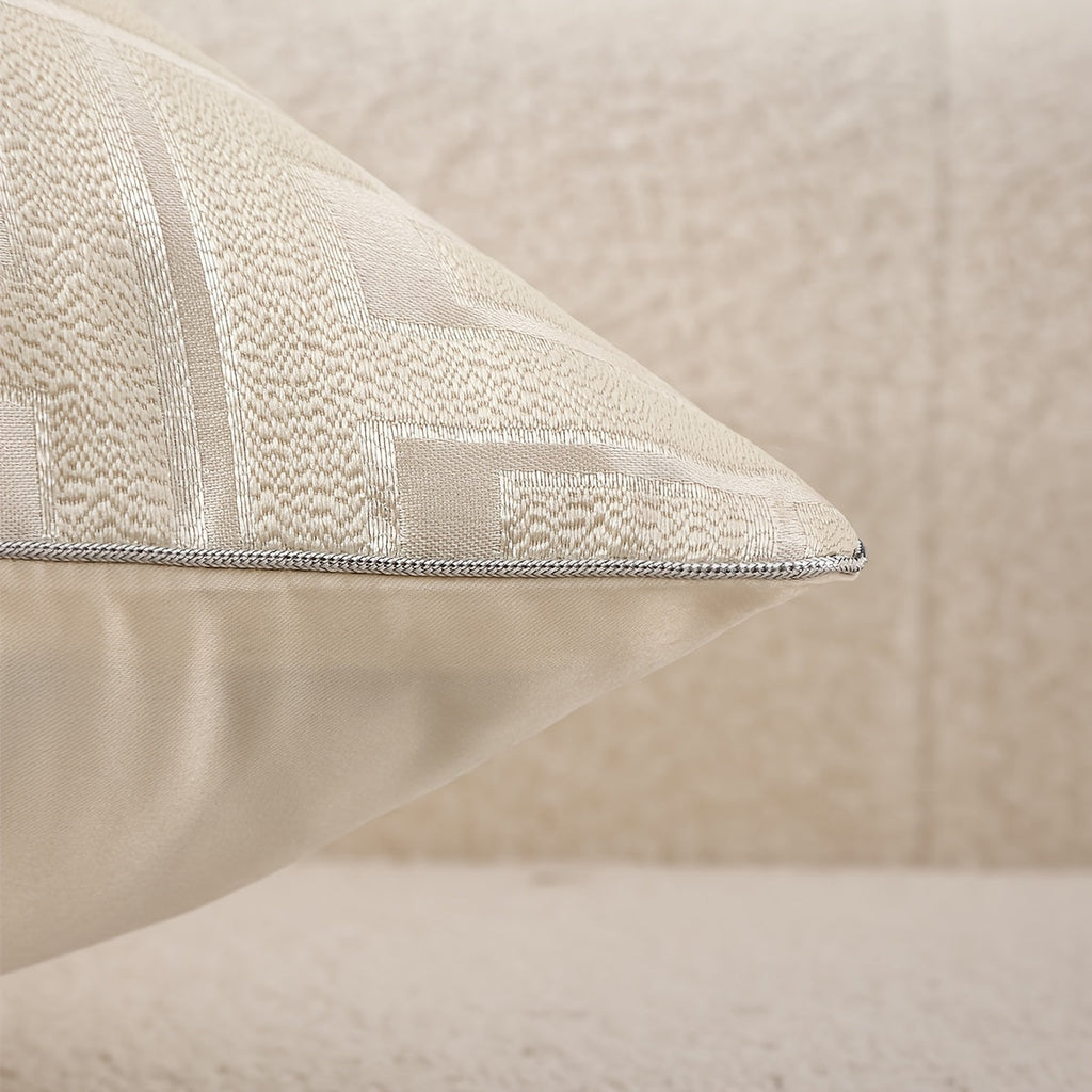 Textured beige pillow on a neutral background