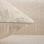 Textured beige pillow on a neutral background