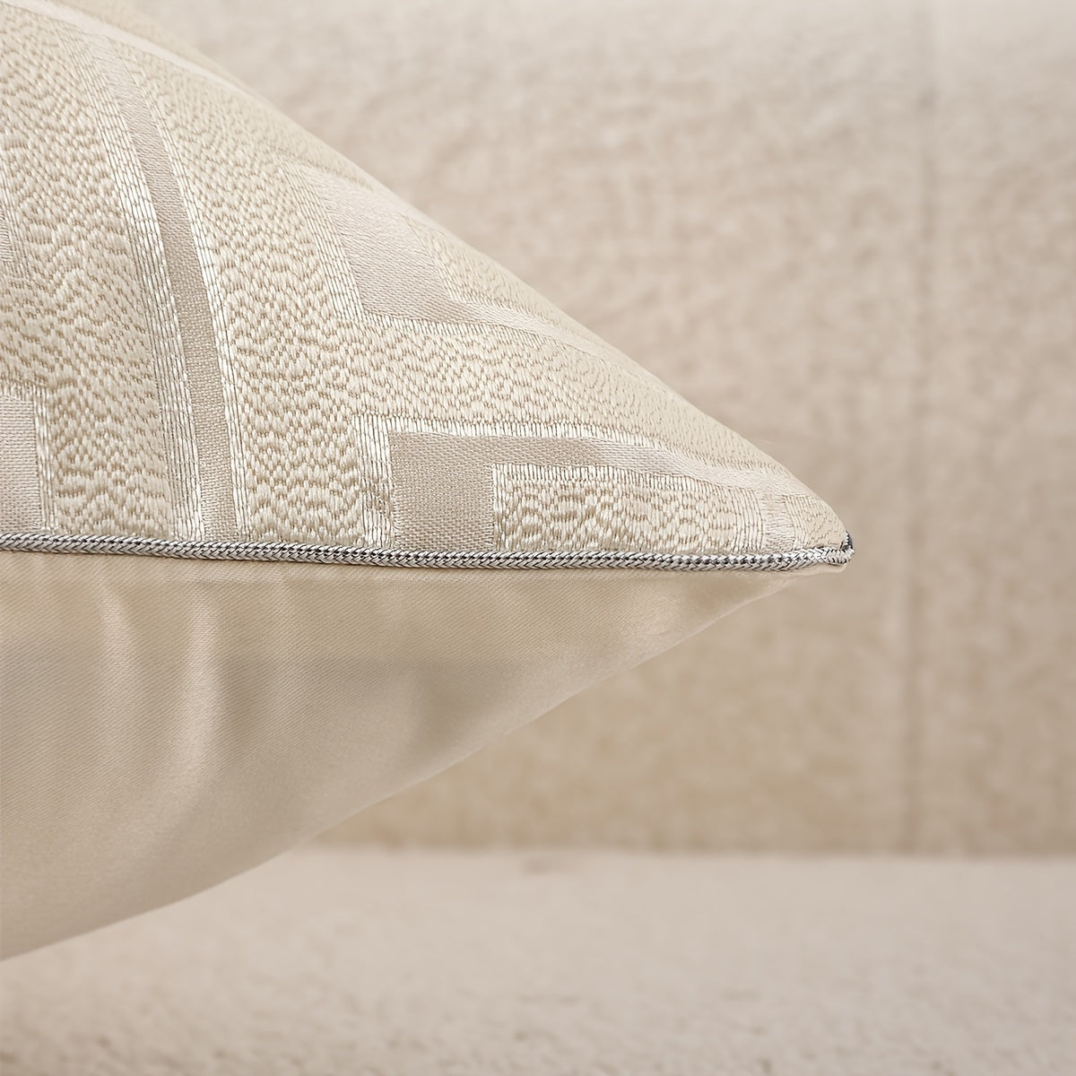 Textured beige pillow on a neutral background