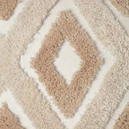 Close-up of a beige shaggy rug with diamond pattern