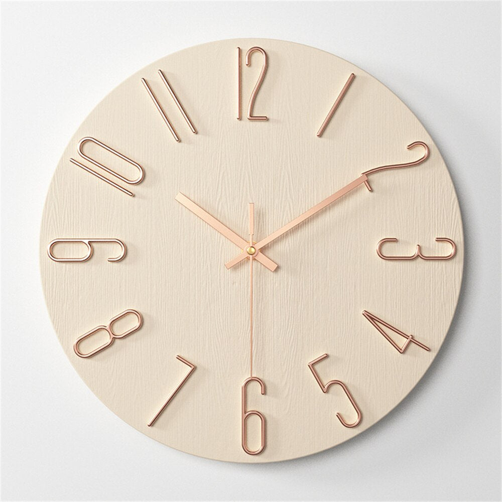 Wooden wall clock with rose gold hands and numbers on a light gray background