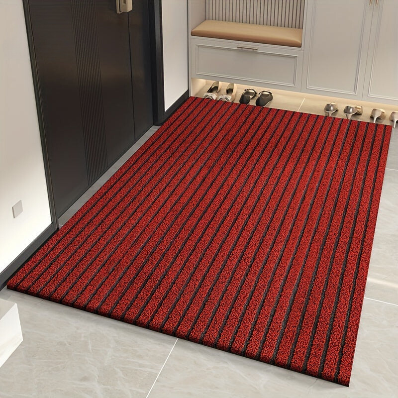 Red striped doormat in front of a door with shoes on a shelf in the background.