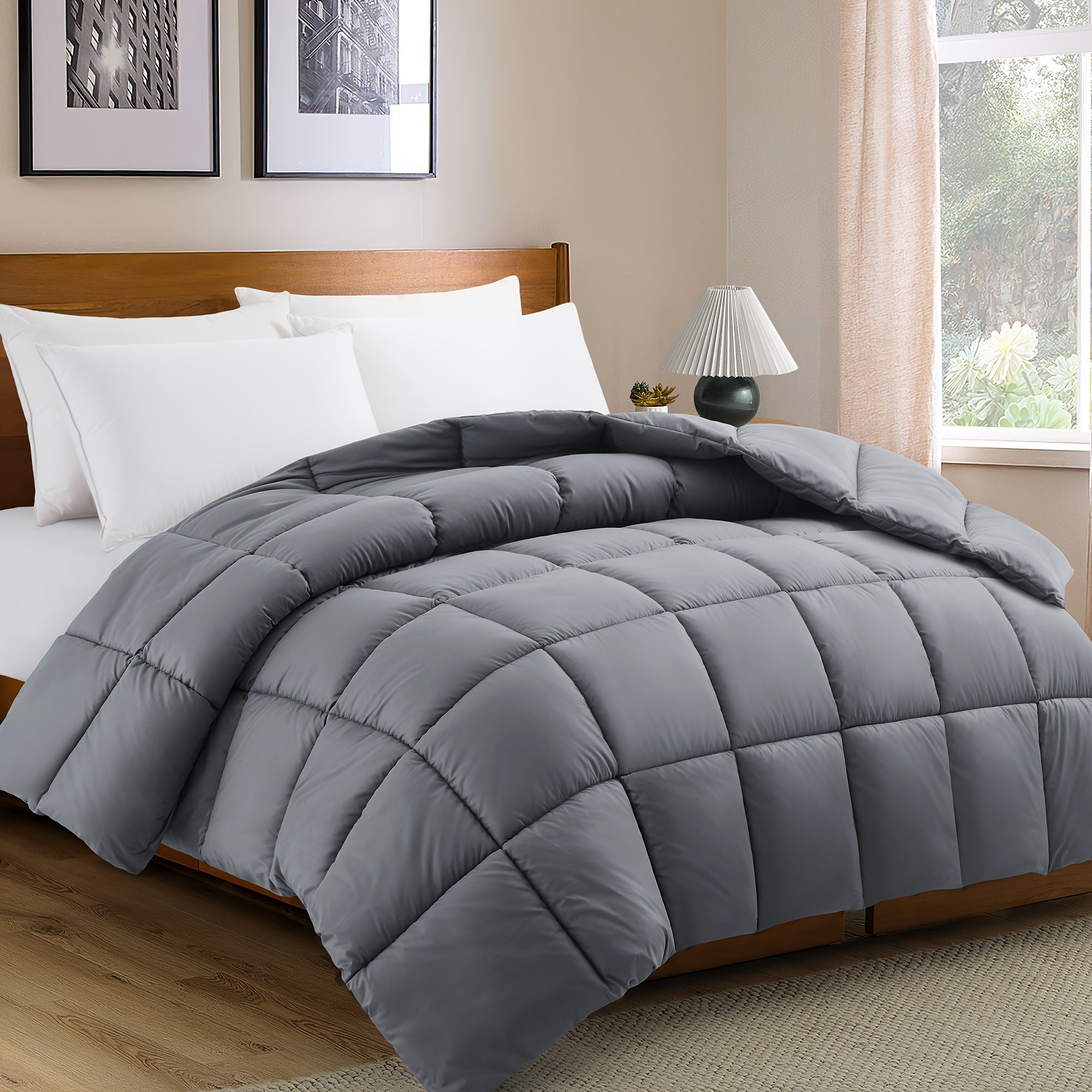 Gray comforter on a bed in a bedroom with a lamp and window.