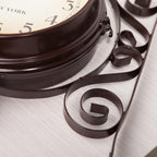 Decorative wall clock with intricate metal design on a light background