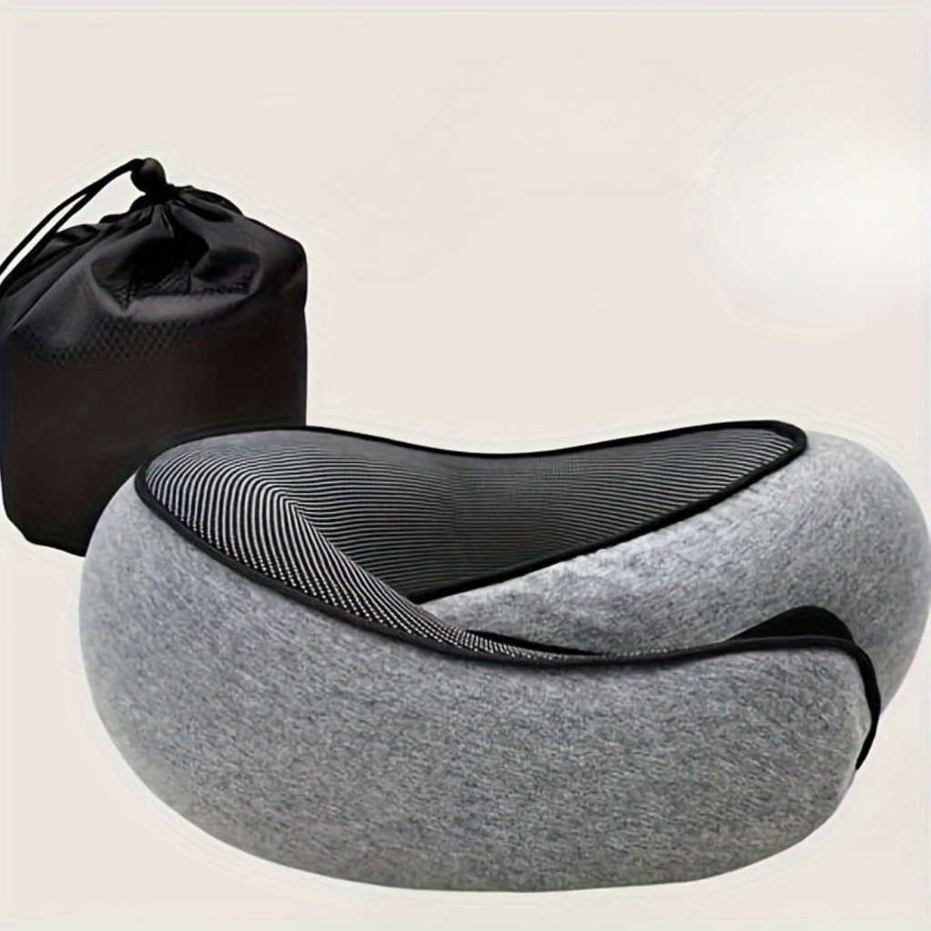 Gray travel neck pillow with black mesh and drawstring bag on a beige background