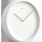 White wall clock with minimal design on a light background