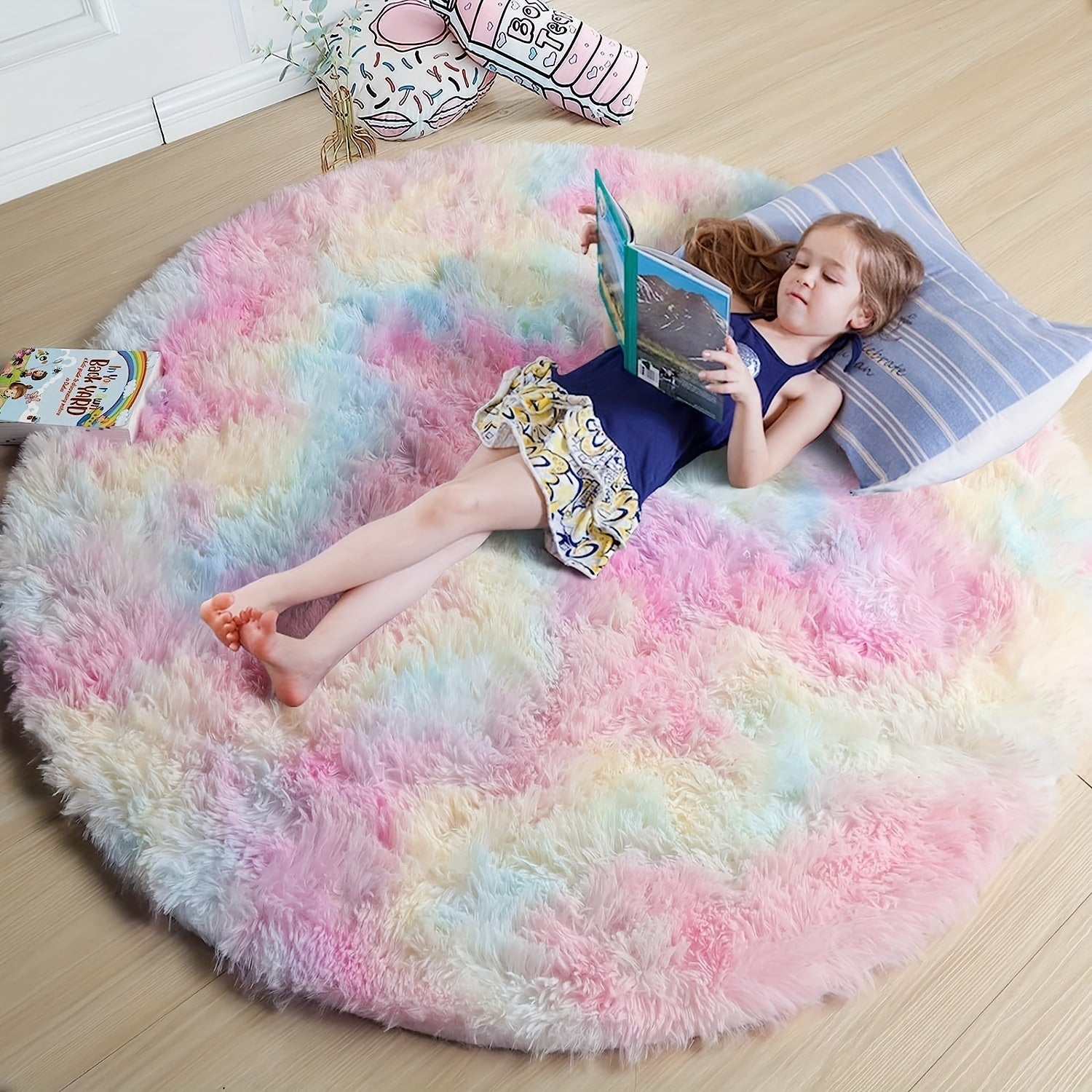 Child reading a book on a colorful fluffy rug in a room.