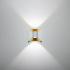 Modern wall light fixture with gold and silver design on a gray background