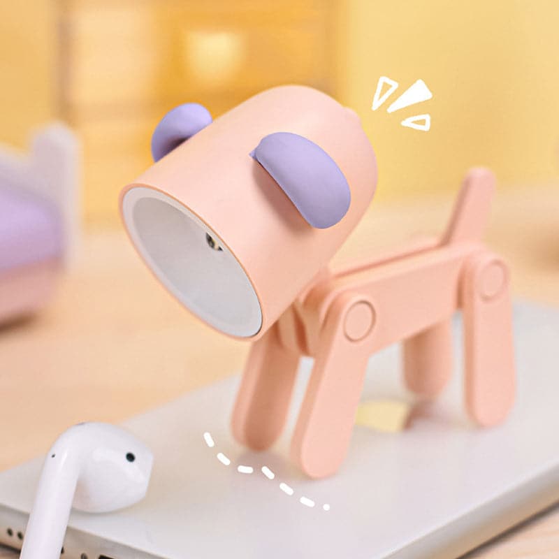 Pink and purple lamp with a clip on a white surface with a yellow background