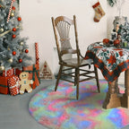 Decorated room with Christmas tree, chair, and table with a colorful rug.